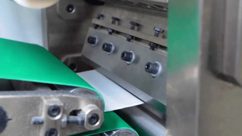 Precision cutting section with rotary knife on a Welldone pet care pad machine