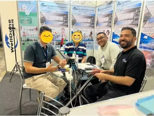 Mostafa discussing hygiene machinery solutions with customers at Egypt exhibition