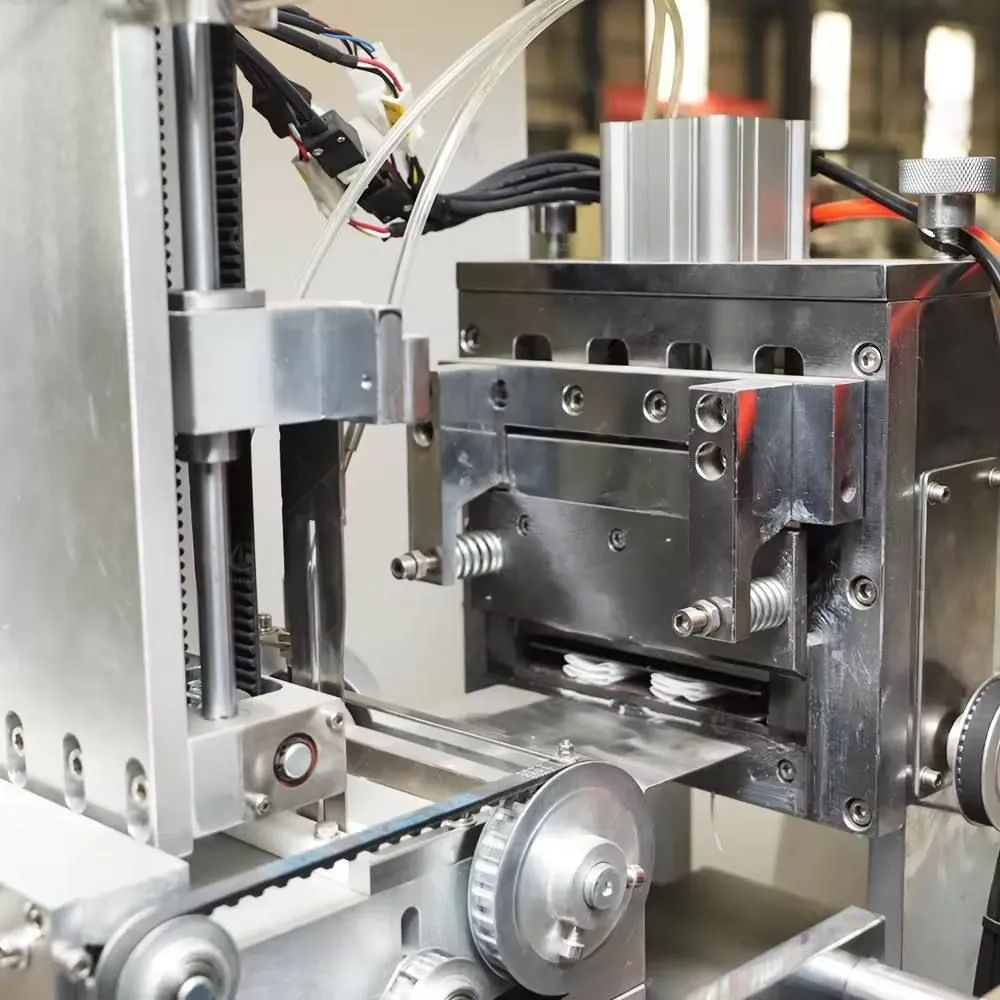 Servo-driven folding and cutting station on a Welldone wet wipes machine with timing belt drive and pneumatic sealing head — fold accuracy and cut edge quality hold only within a validated substrate GSM window