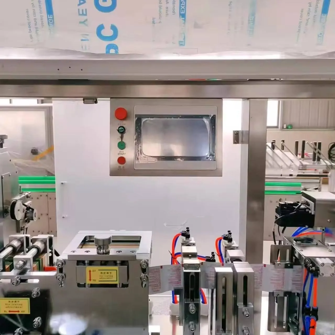 Touchscreen HMI control panel and heat sealing station on a Welldone wet wipes production line — the recipe system applies setpoints without knowing whether the product falls inside the validated design envelope