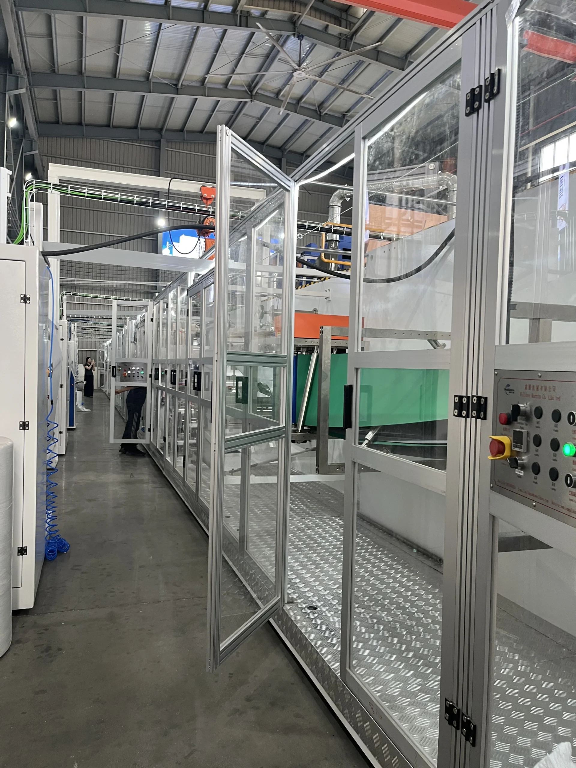 Adult care production line inside its safety enclosure
