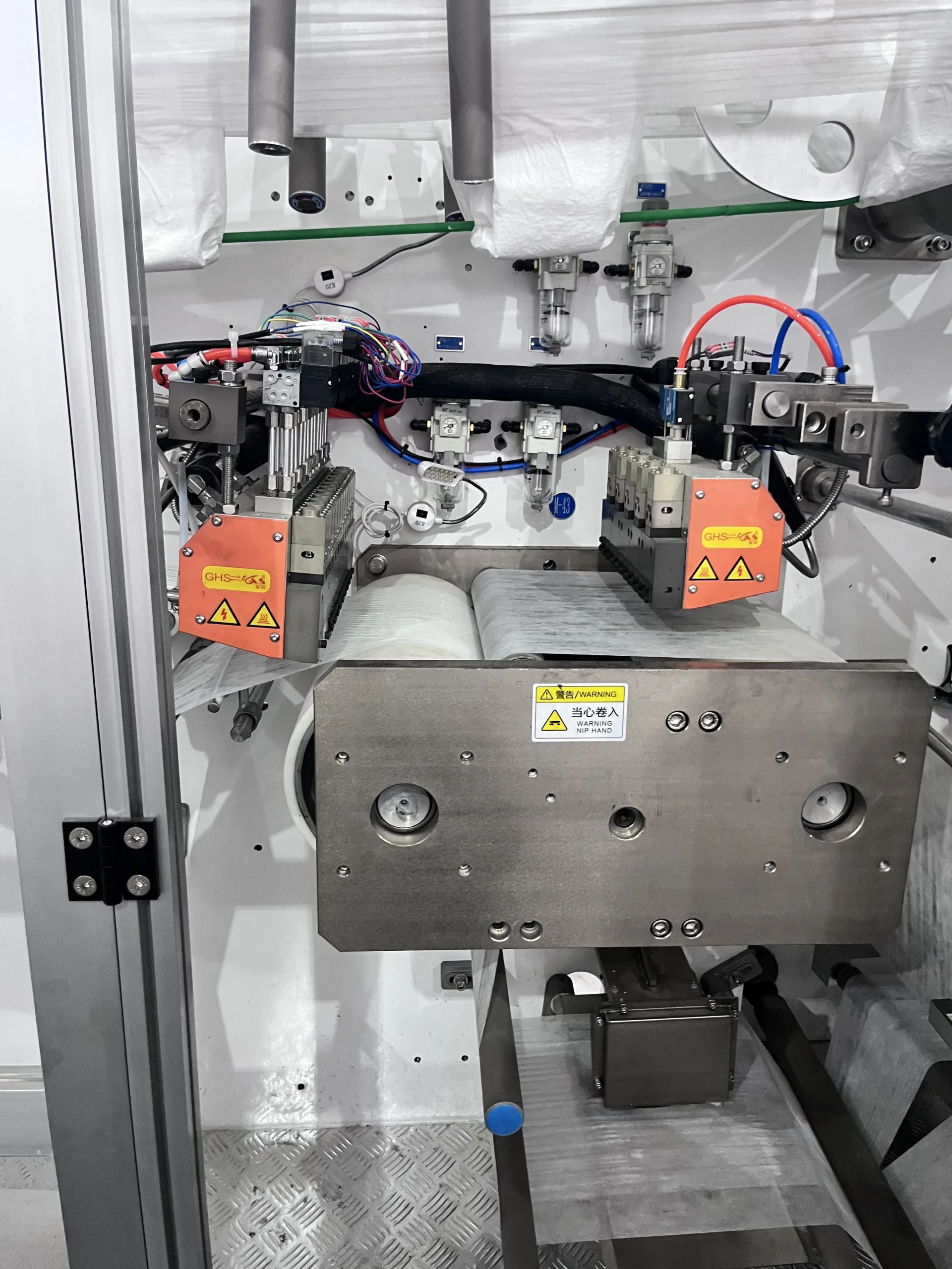 Waistband lamination and adhesive application station