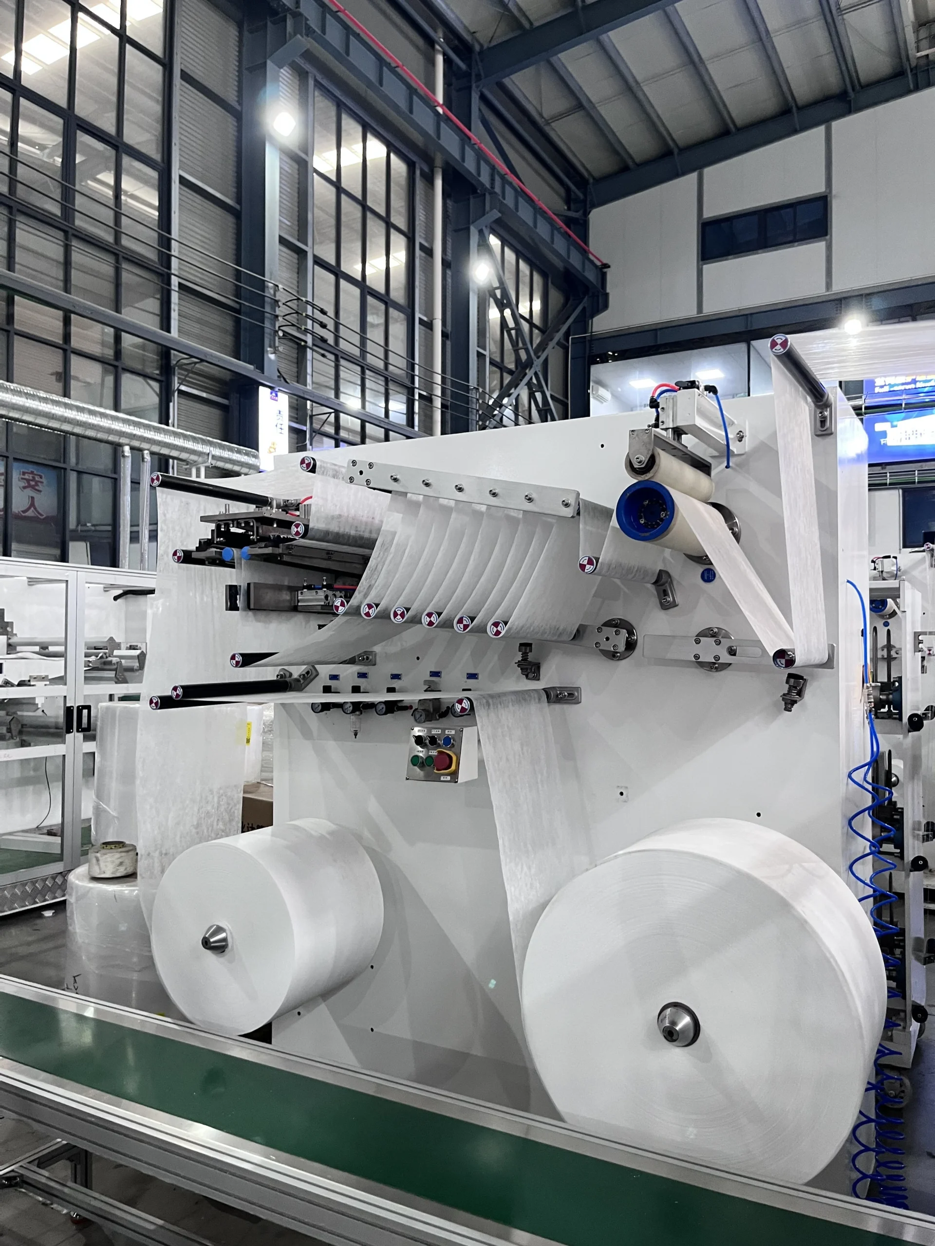 Waistband nonwoven lamination section on a baby pull-up diaper machine